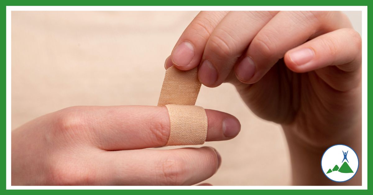 The human body: person putting plaster on finger